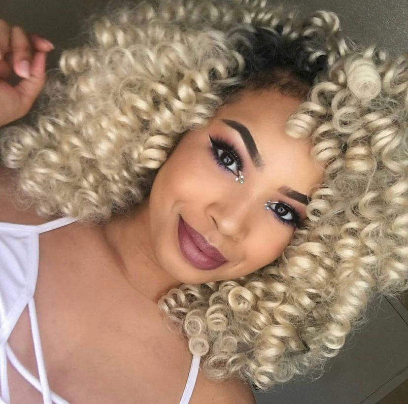 Full view of a lady rocking  blond Crochet Curls