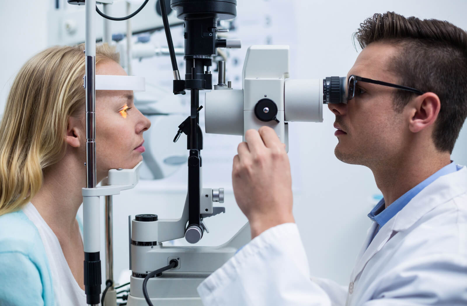 An optometrist performing a slit-lamp exam to detect eye problems