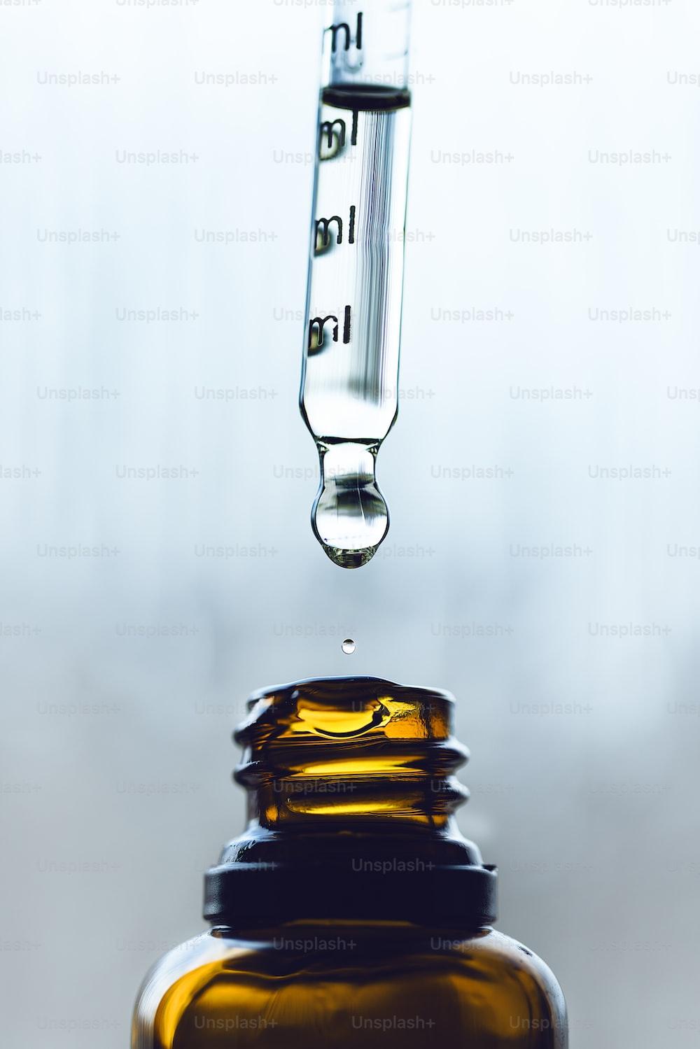 a dropper filled with a liquid sitting on top of a bottle