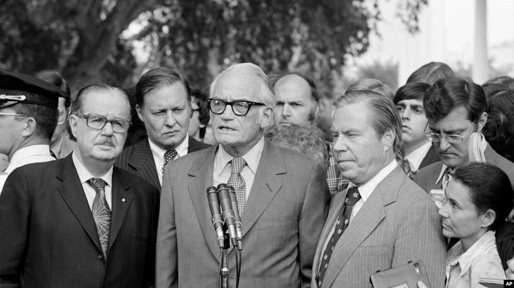FILE - Sen. Barry Goldwater, R-Ariz., center, speaks after meeting with President Richard Nixon, Aug. 7, 1974, about resigning. With him are Senate Republican Leader Hugh Scott of Pennsylvania, left, and House GOP Leader John Rhodes of Arizona,