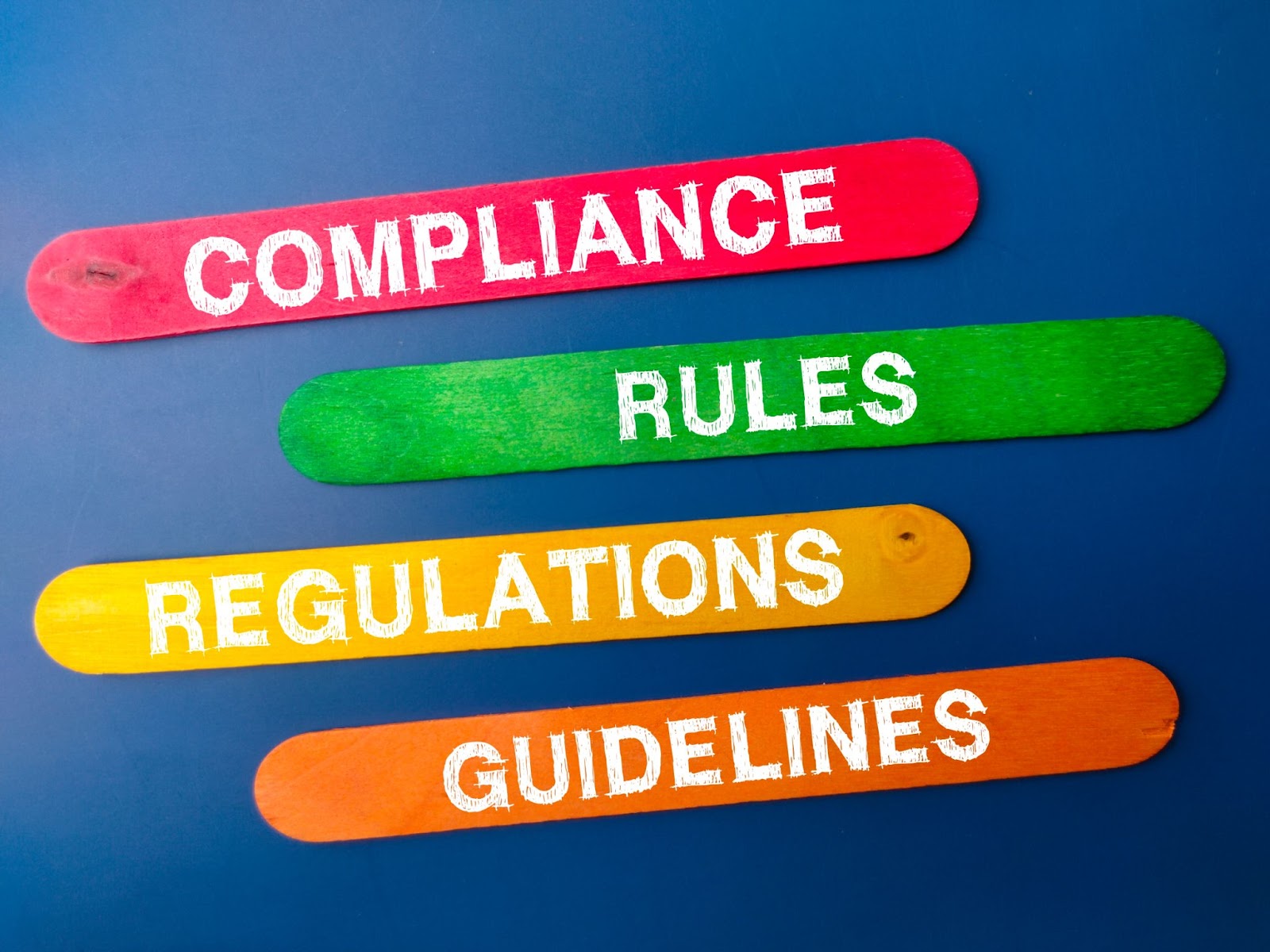 Popsicle sticks that have the following words on them: compliance, rules, regulations, and guidelines. 