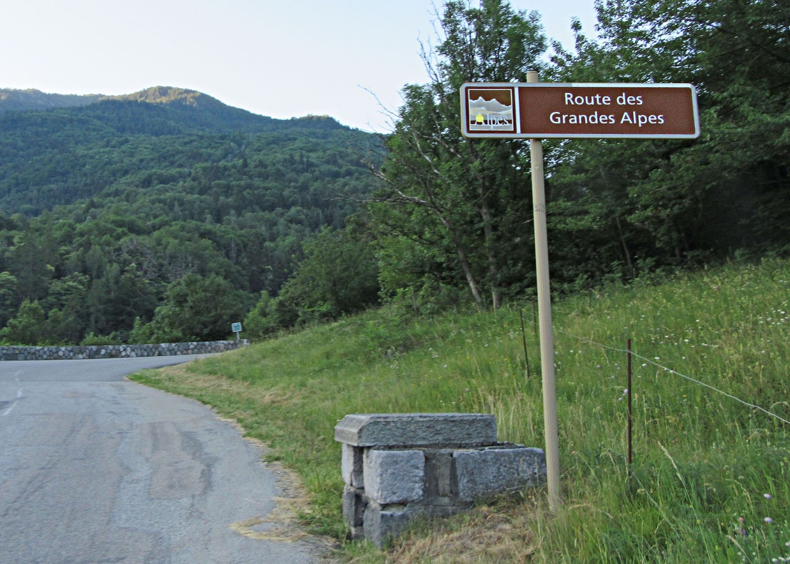 Cycling Col du Galibier from Valloire: stone bricks next to sign for Route des Grandes Alpes