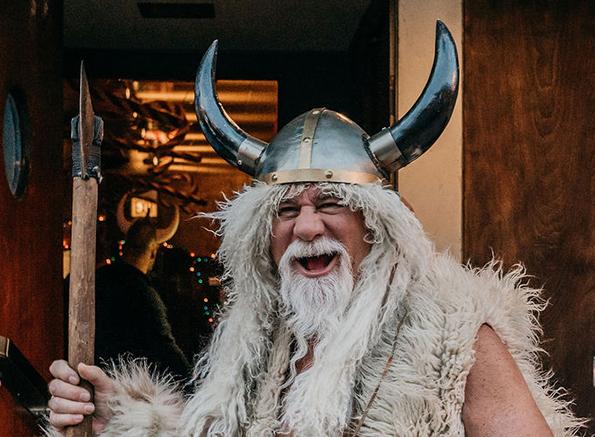 A person in a viking garment

Description automatically generated