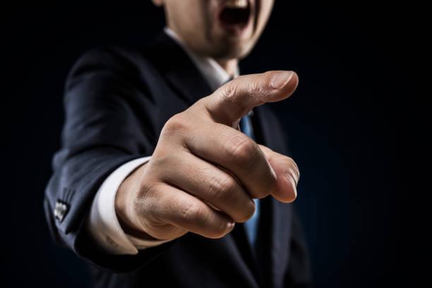 Businessman sticks out a finger and reproves it. Businessman sticks out a finger and reproves it. Bullying stock pictures, royalty-free photos & images