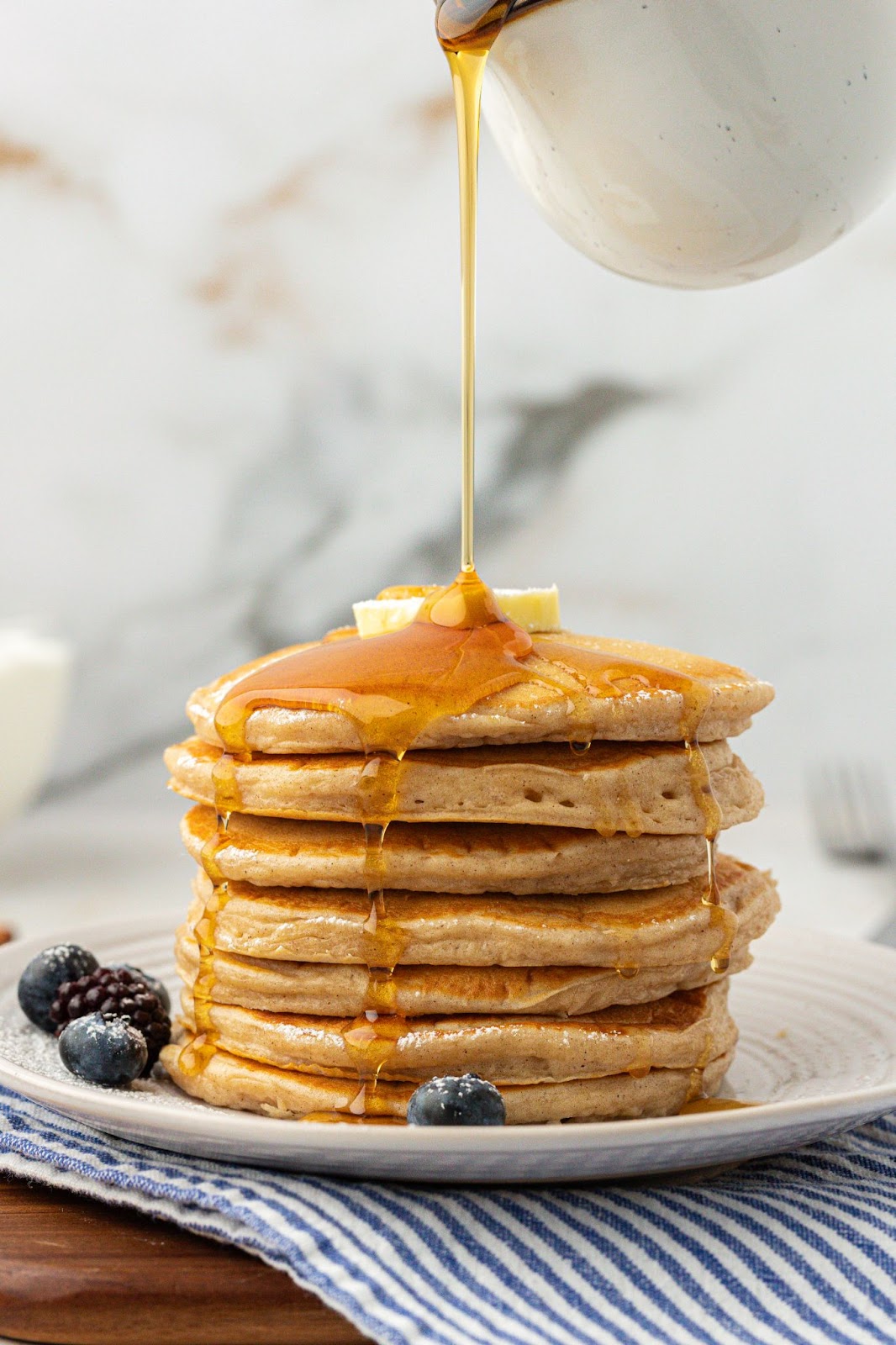 syrup poured over a stack of greek yogurt pancakes