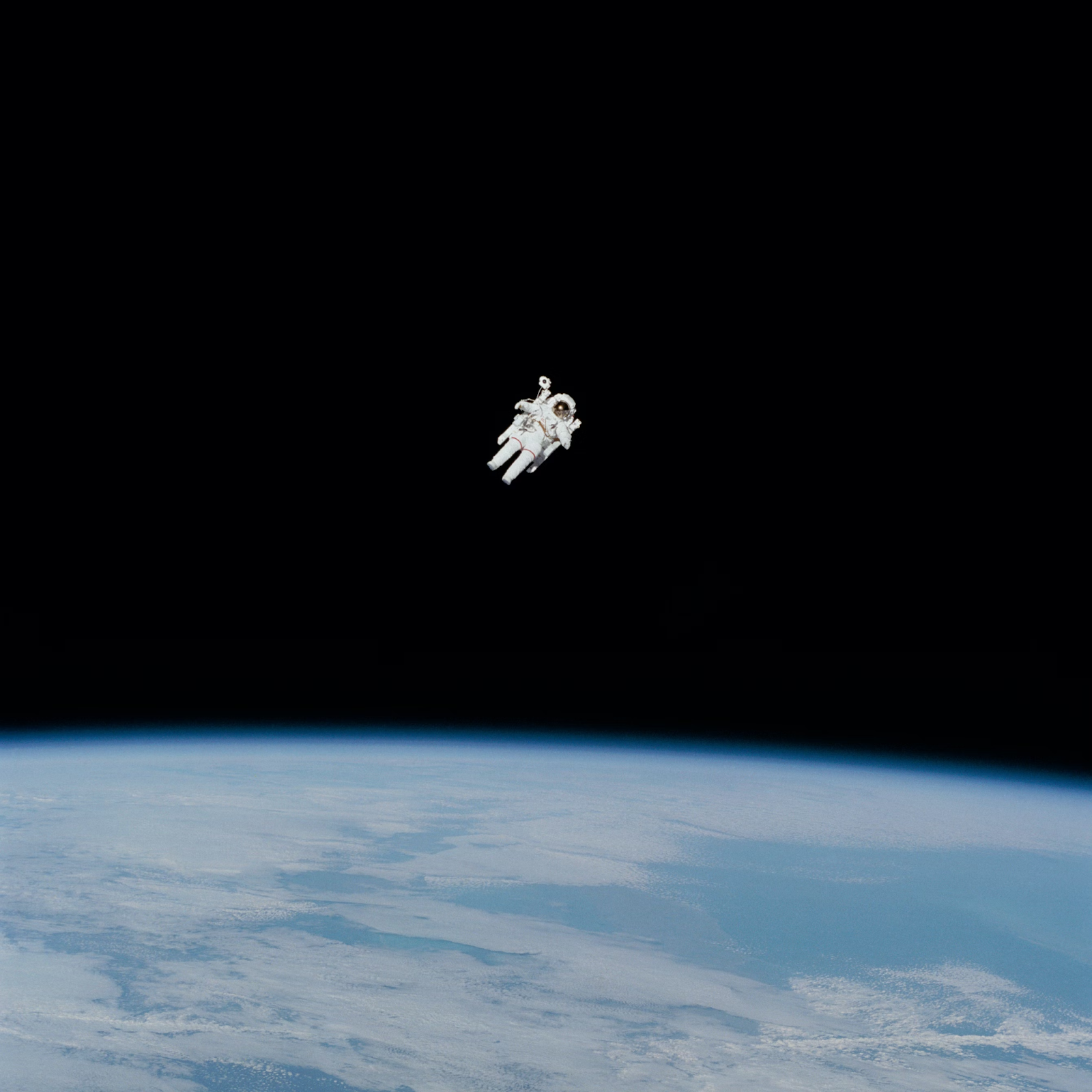 Astronaut floating in space above Earth.