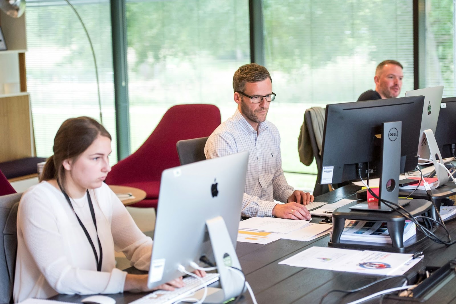 IT professionals working on computers in an office setting.