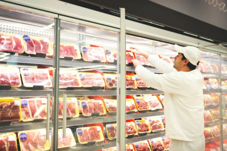 Meat selection stored in a commercial refrigerator in a supermarket.