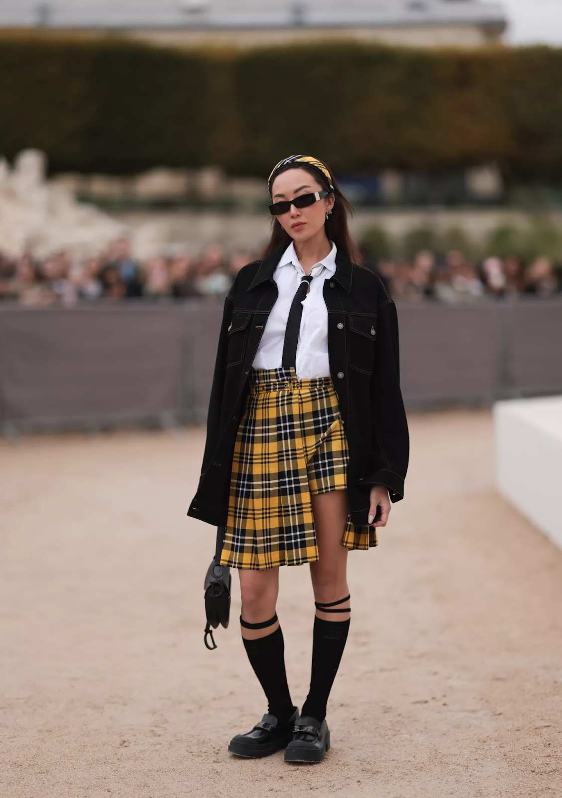 lady rooking black loafers with sunglasses