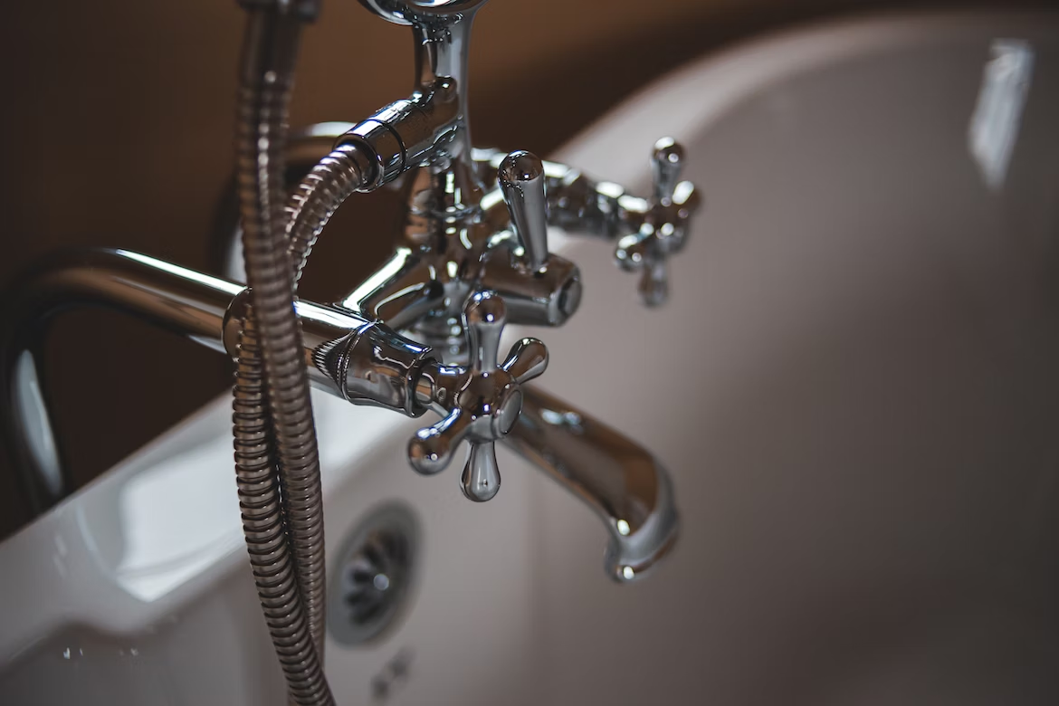 a close up of a bathtub faucet
