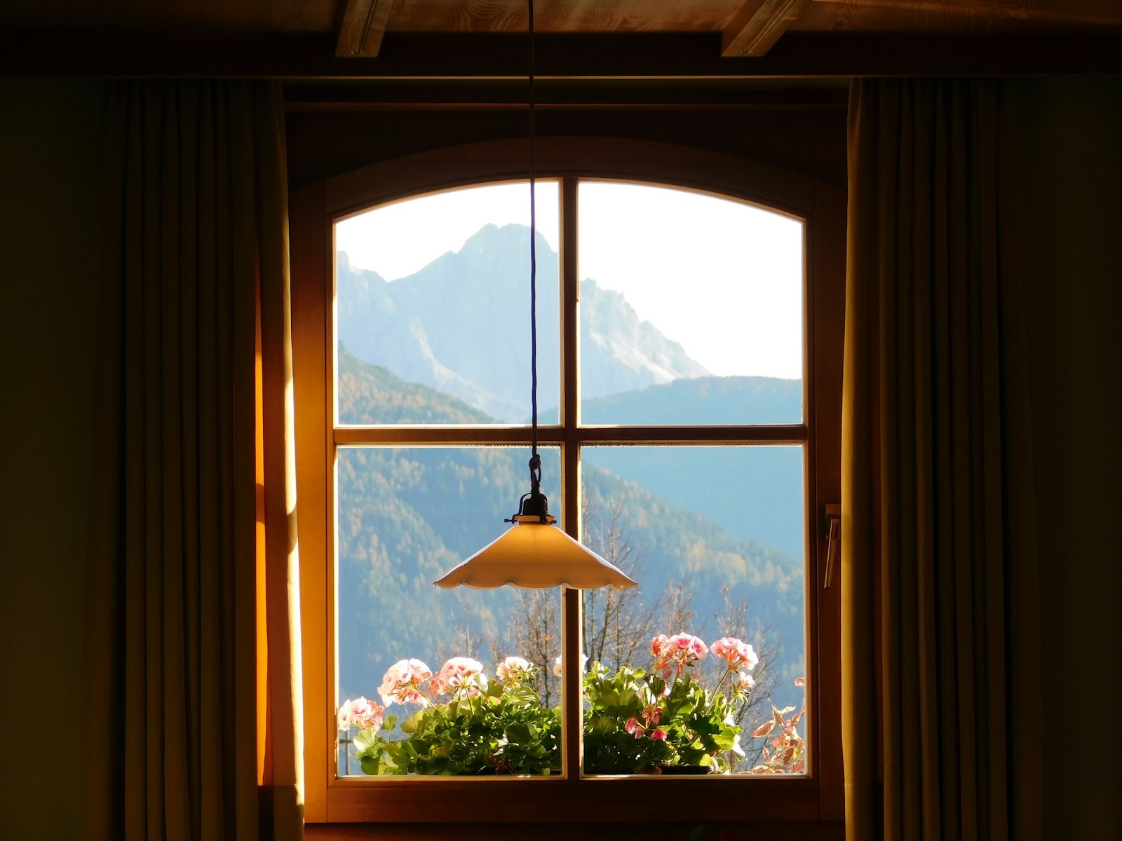 a window looking at the mountains