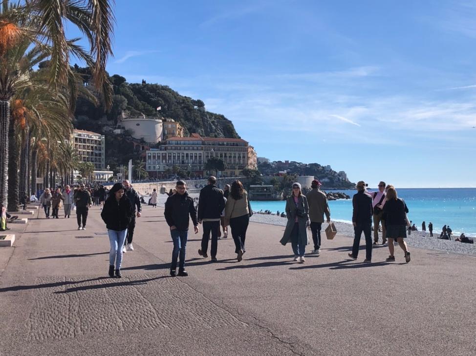 A group of people walking on a beach

Description automatically generated