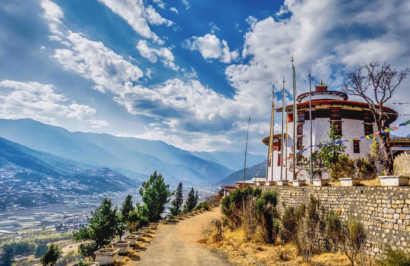 C:\Users\User\Downloads\mountain-village-with-rural-road-on-a-sunny-summer-day-Bhutan.jpg