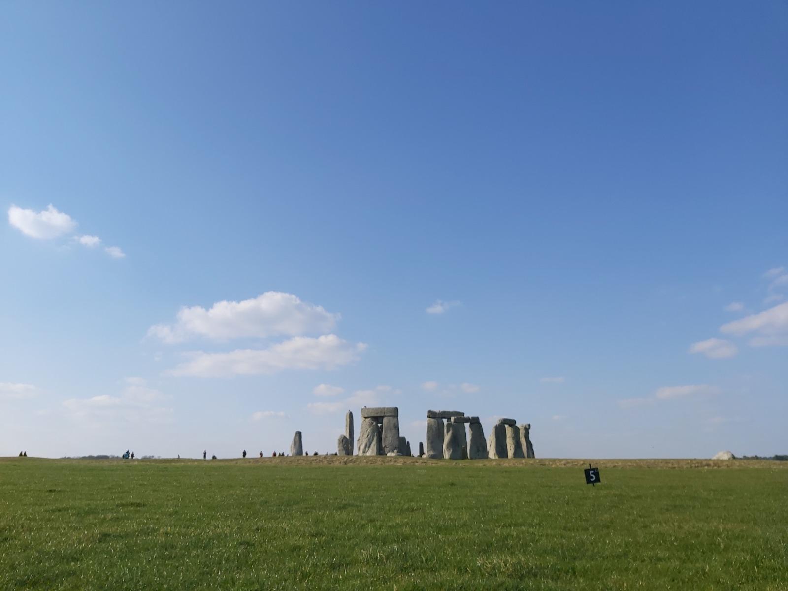 A large grassy field with stone pillars

Description automatically generated with medium confidence