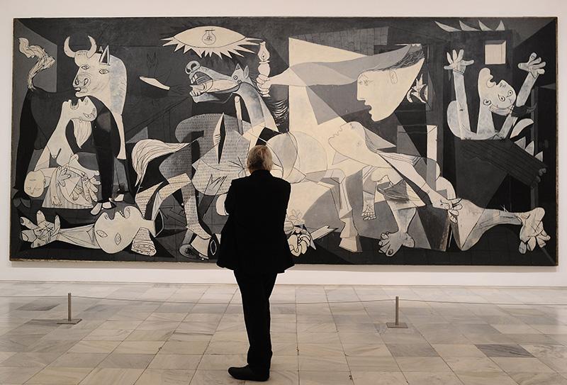 A person looking at a wall of art

Description automatically generated with low confidence