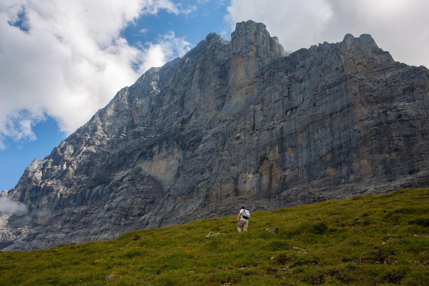 A person standing on a grassy hill

Description automatically generated