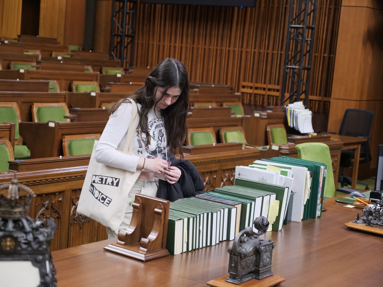 Finalist, Maia Cassie admires the books on display in the House of Commons. 