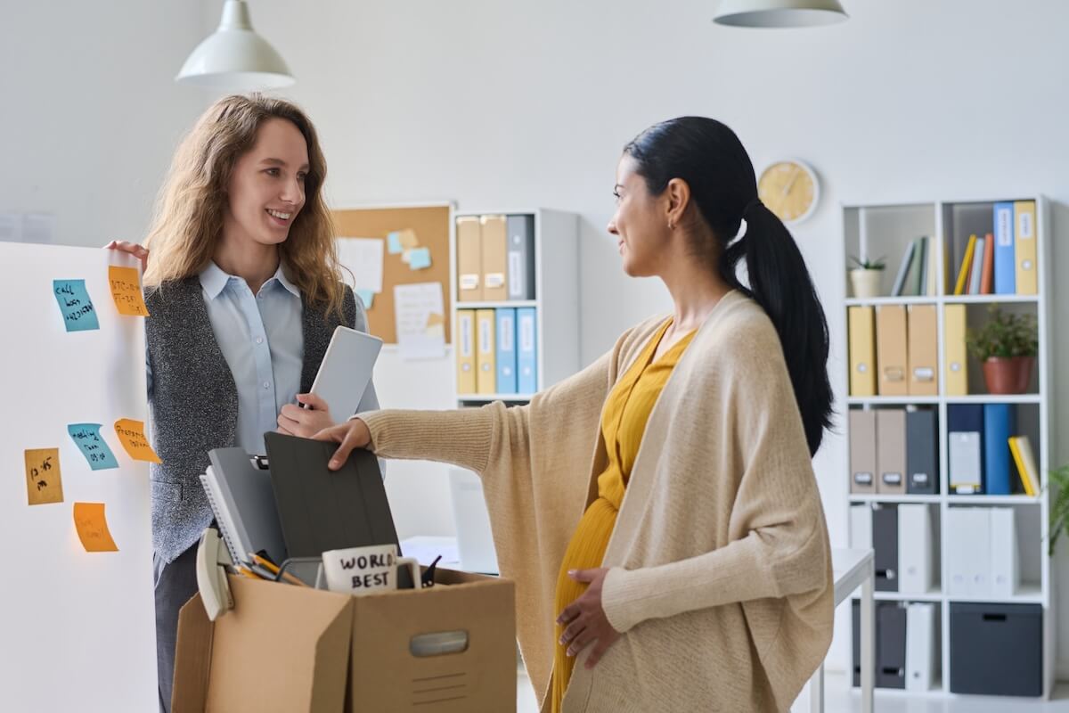 Pregnant employee putting her things in a box