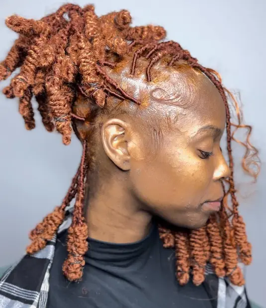 Picture of a b lady rocking a copper hair with knots 