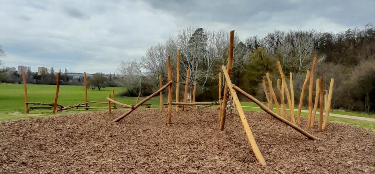 A wooden structure in a park

Description automatically generated