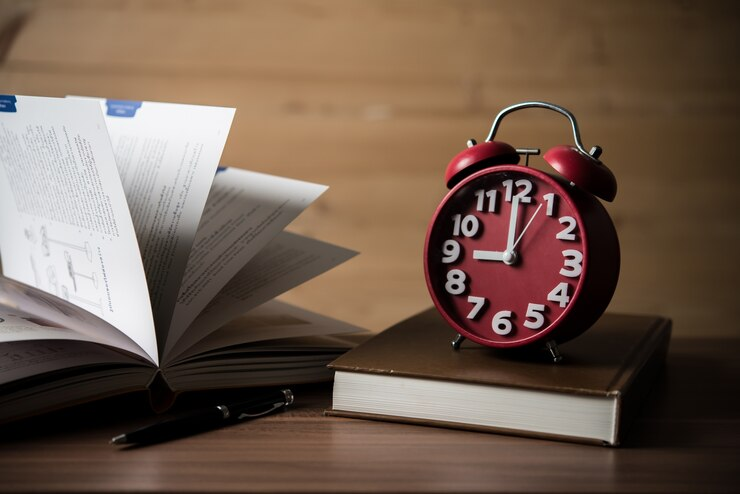 Wooden background with a clock showing exam time.