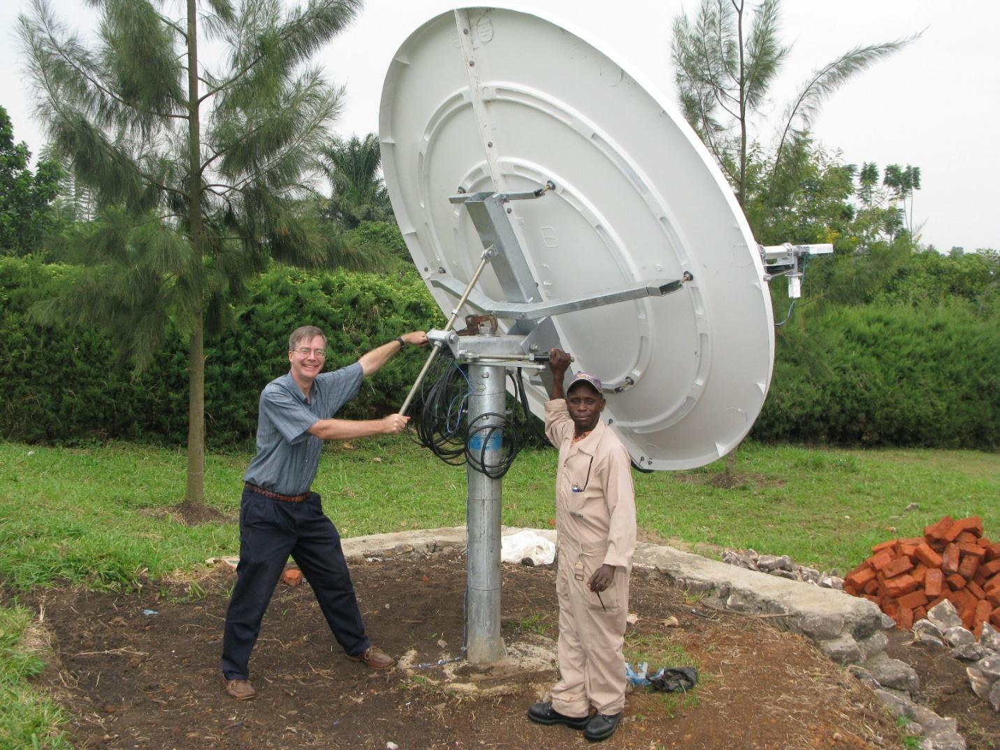 Men working on a satellite dish

Description automatically generated