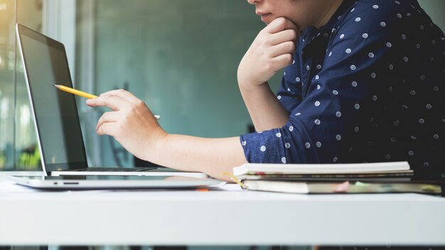 A student working on a laptop, symbolizing the dedication required for medical exams.