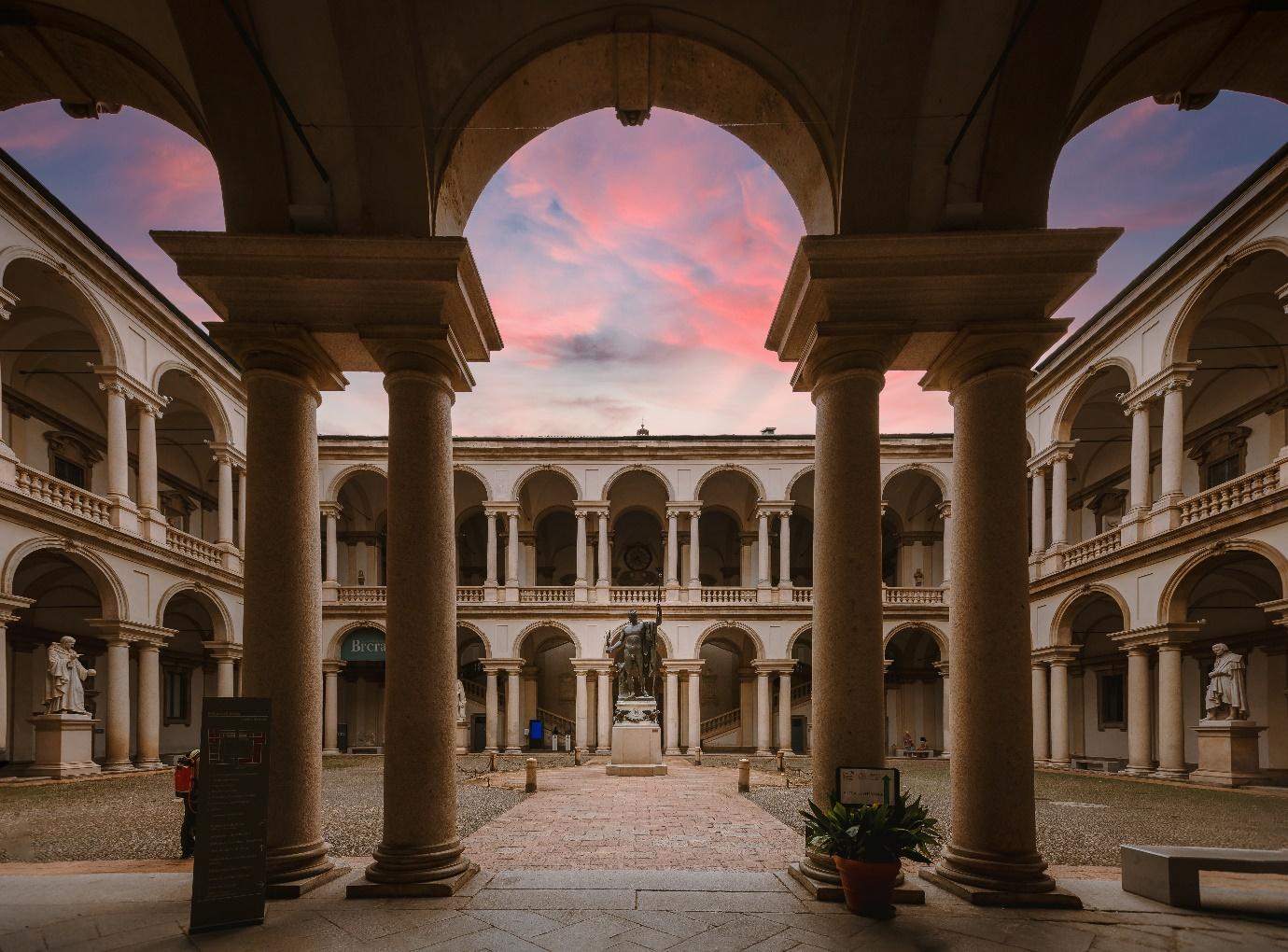 A courtyard with columns and arches

Description automatically generated