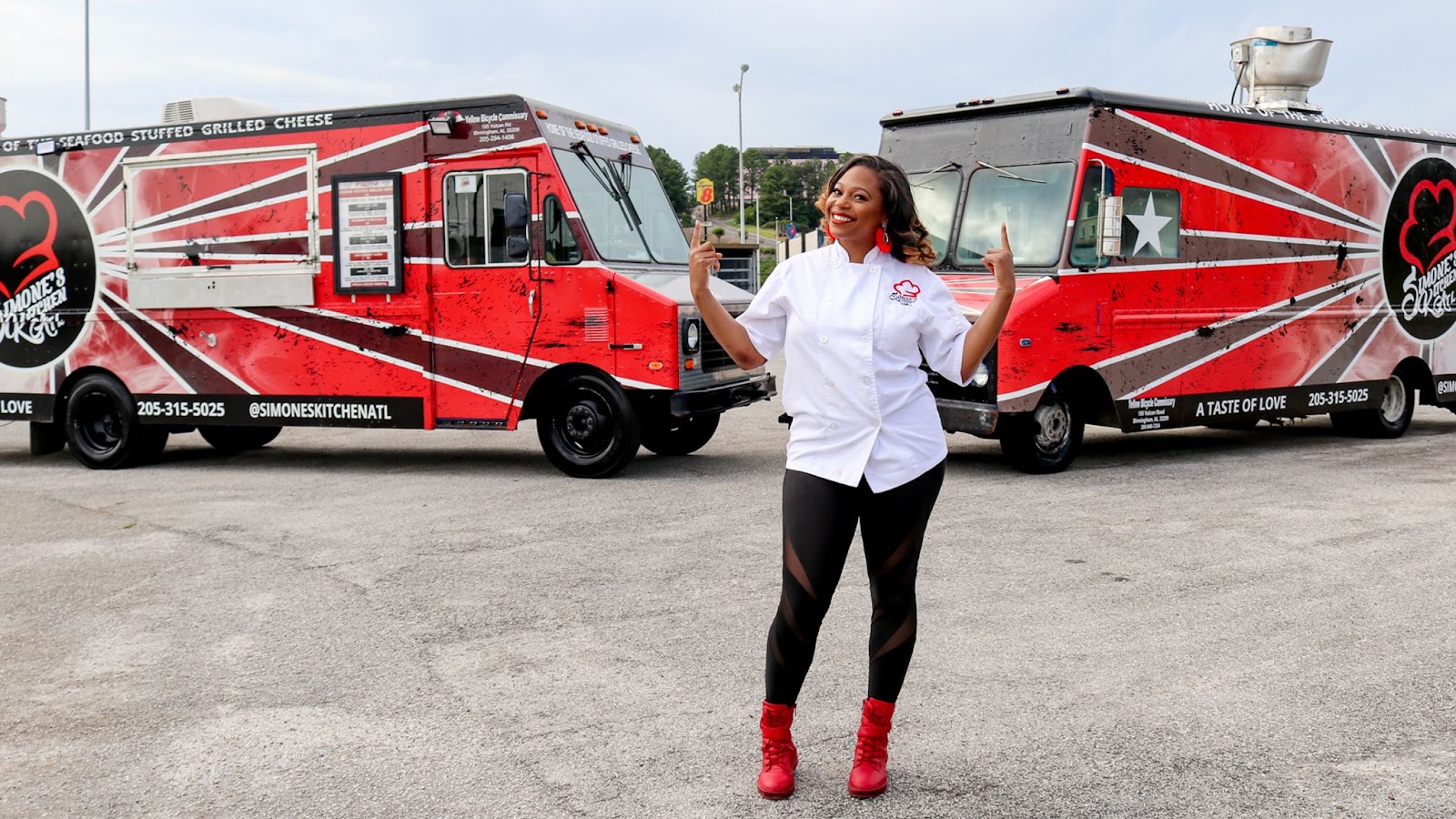 Simone Generette standing in front of her two Simone's Kitchen ATL food trucks.