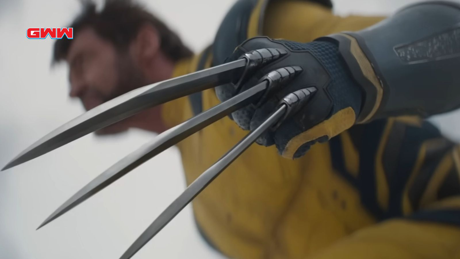 Close-up of gloved hands with metal claws extended.