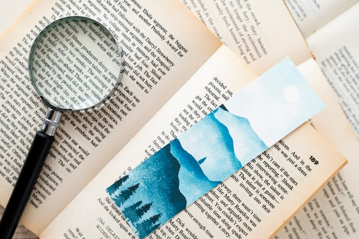 A top view of a neat arrangement of bookmarks nestled between open books.