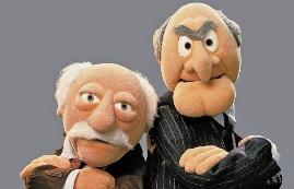 Two puppets with their arms crossed

Description automatically generated