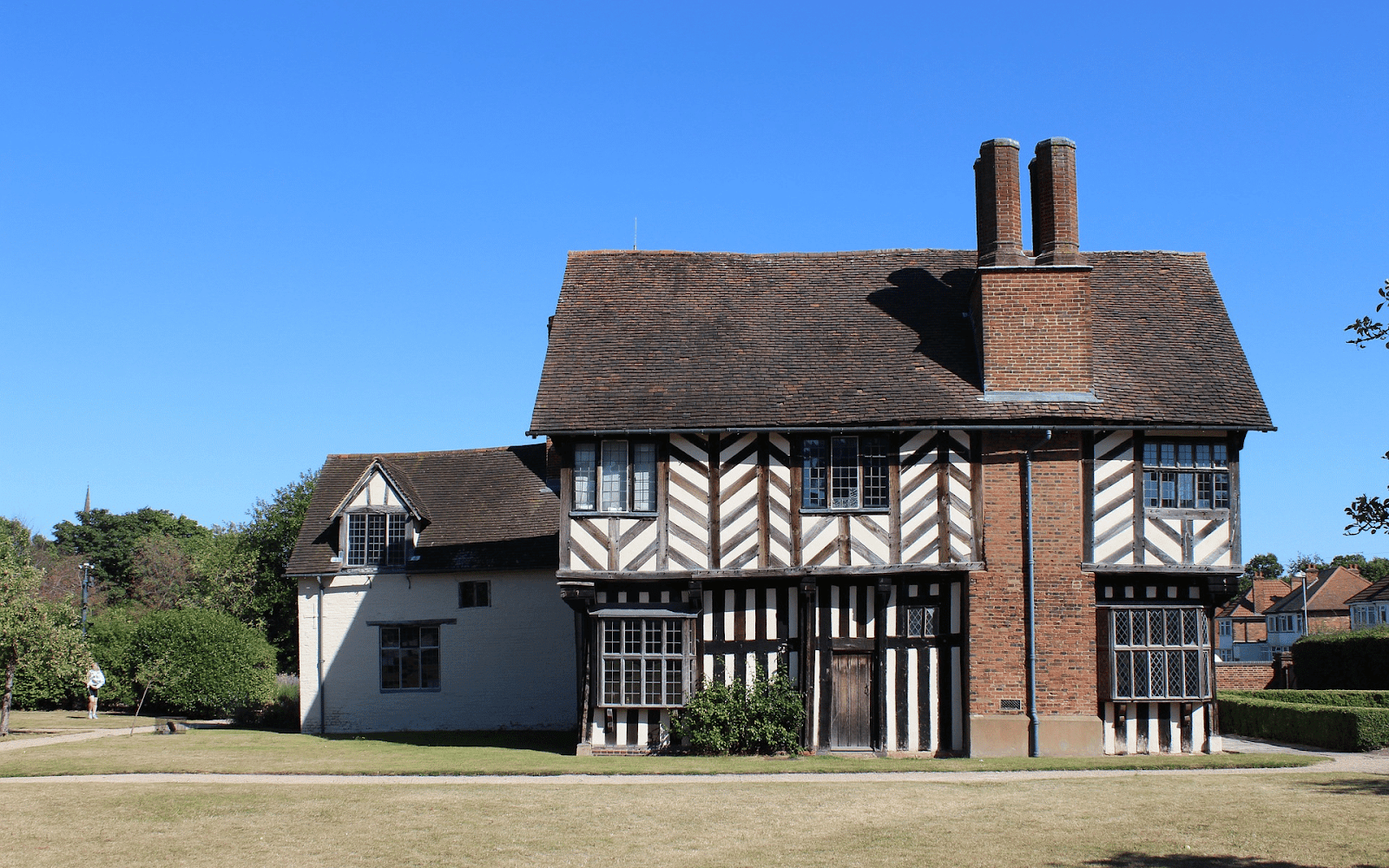 A house with a brick and wood frameDescription automatically generated with medium confidence