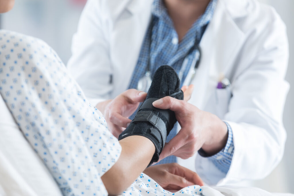 personal injury victim getting a cast wrapped on their wrist by a doctor