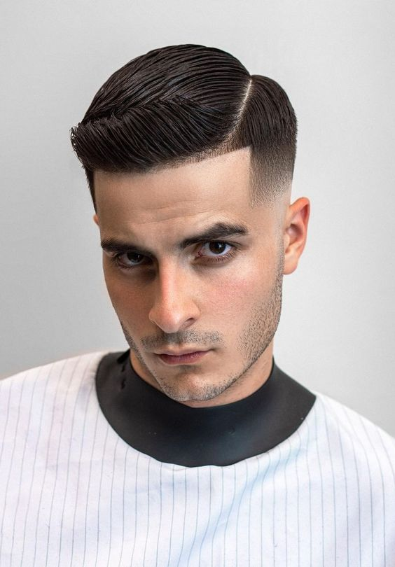 Picture showing a guy rocking a side part hair with a fade underneath