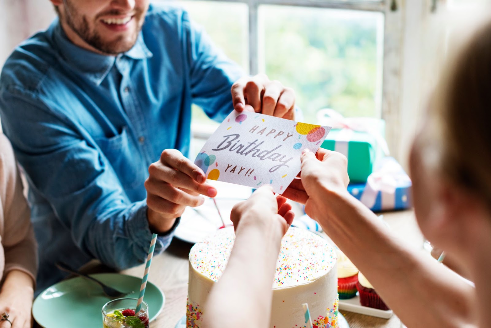 Man Giving Birthday Wishing Card to Friend