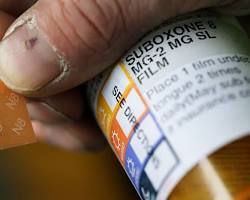 person holding a prescription bottle of Suboxone