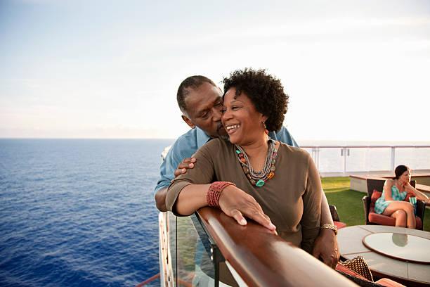 couple on railing on deck - black lovers stock pictures, royalty-free photos & images