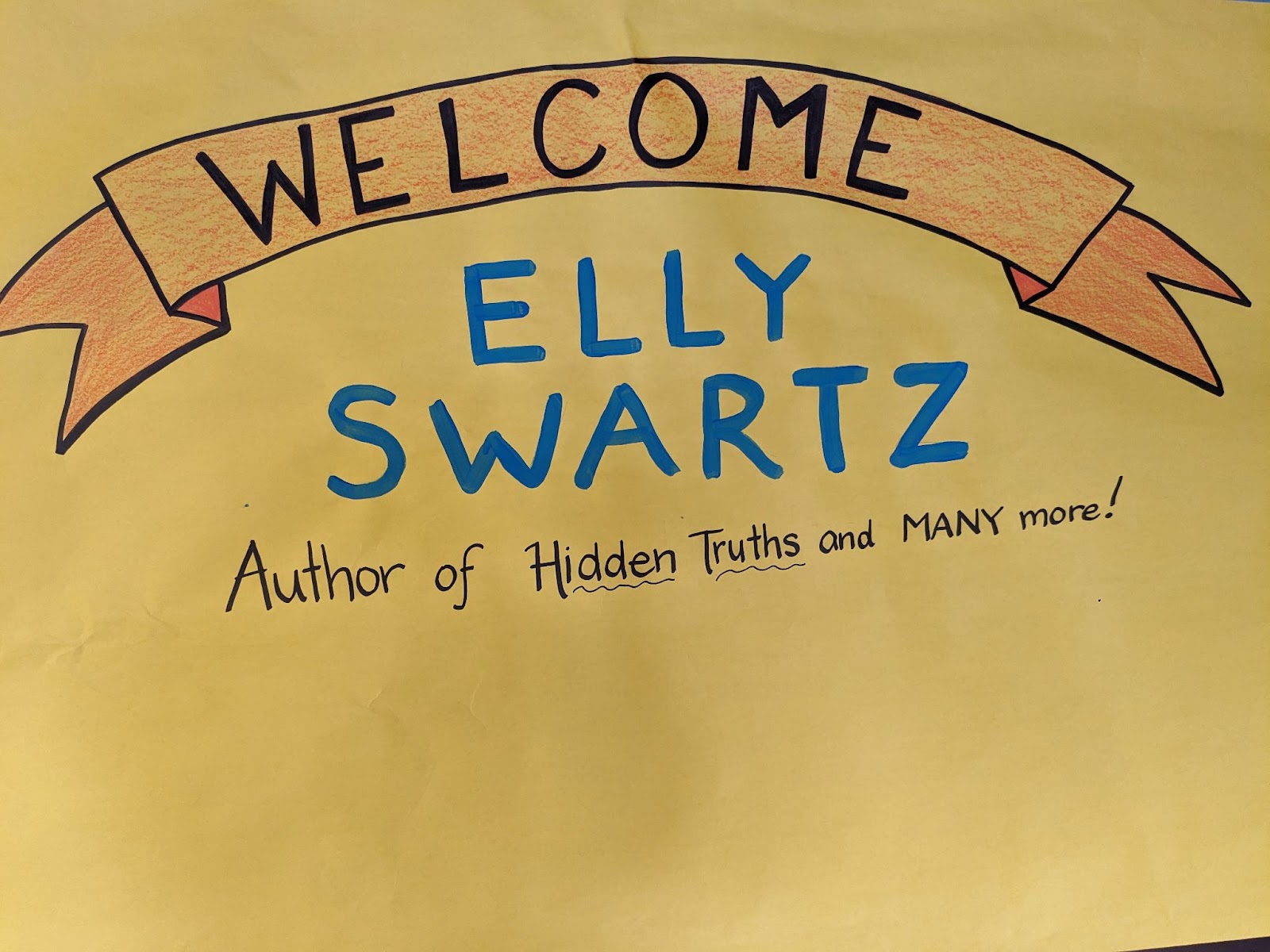 Poster made for our guest author Elly Swartz on yellow paper and blue writing.