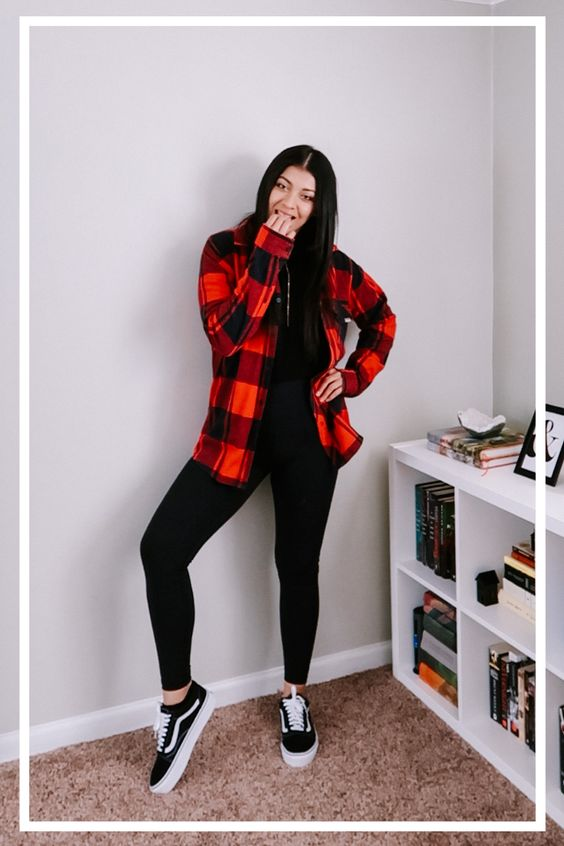 Picture showing a lady rocking a plaid shirts with an all black outfit and the sneakers