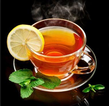 A cup of tea with a lemon slice and mint leaves

Description automatically generated