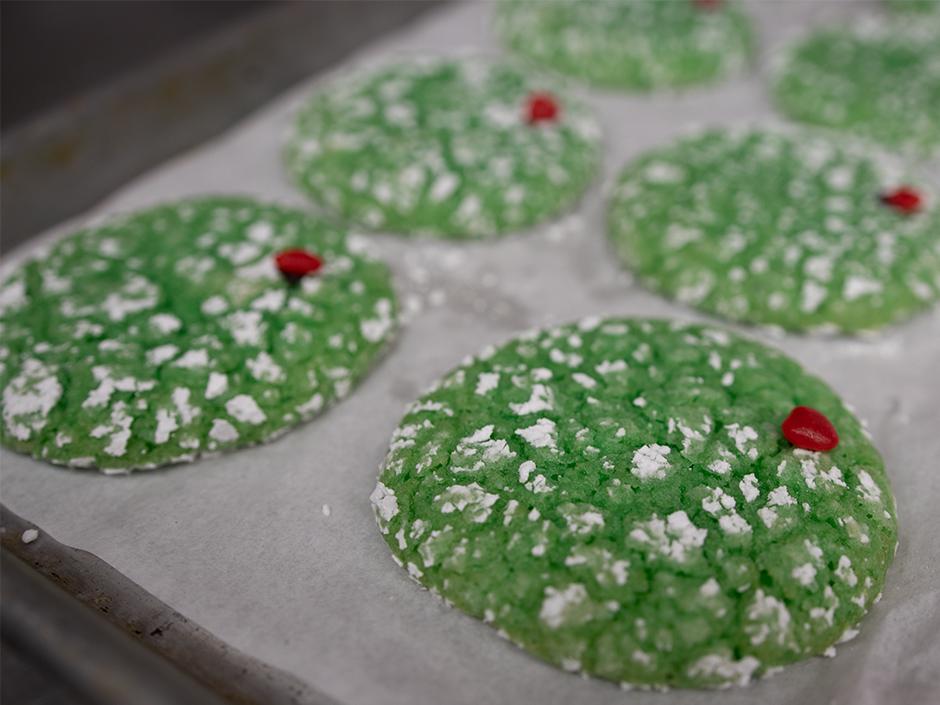 A tray of green cookies
