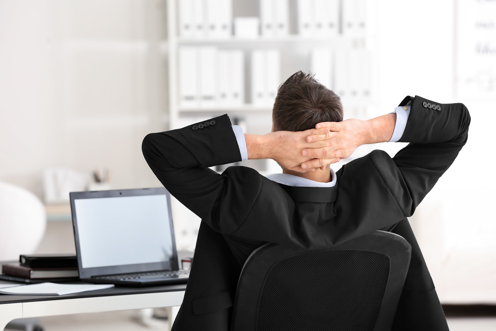 A man relaxing on the swivel chair in the office