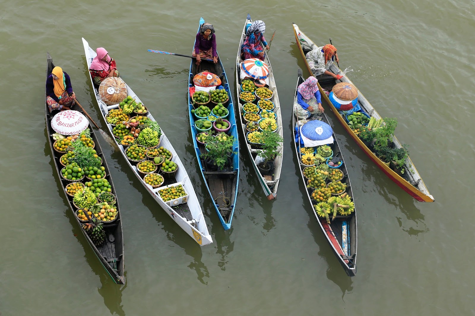 Vibrant Mekong Culture - Locals trading goods at a bustling floating market.

