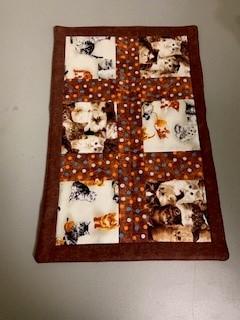 A table runner with a pattern of cats

Description automatically generated