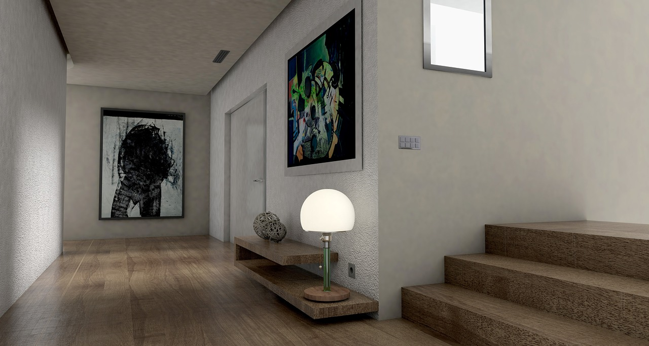 an interior setting with white walls, a bright lamp, and multiple large prints on the wall