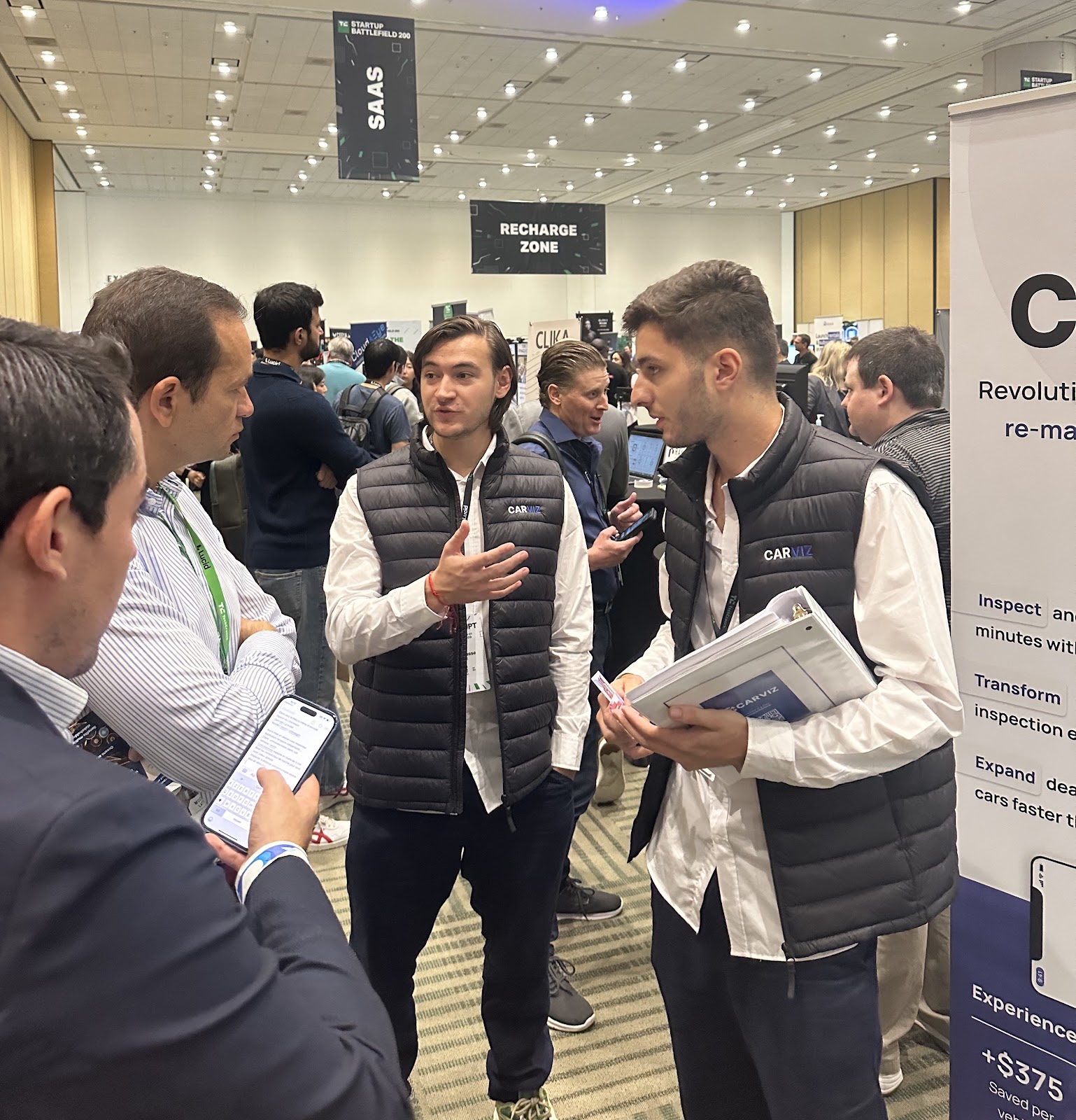 Carviz CTO Evan Barberousse (middle) and CEO Côme Pinczon du Sel (right) speak with investors at the 2023 TechCrunch Disrupt Conference in San Francisco