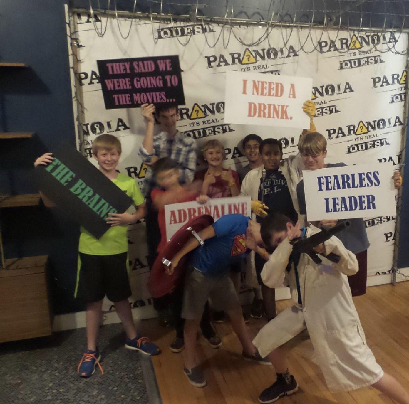 The picture shows a group of kids dressed up for escape rooms and flaunting their roles.