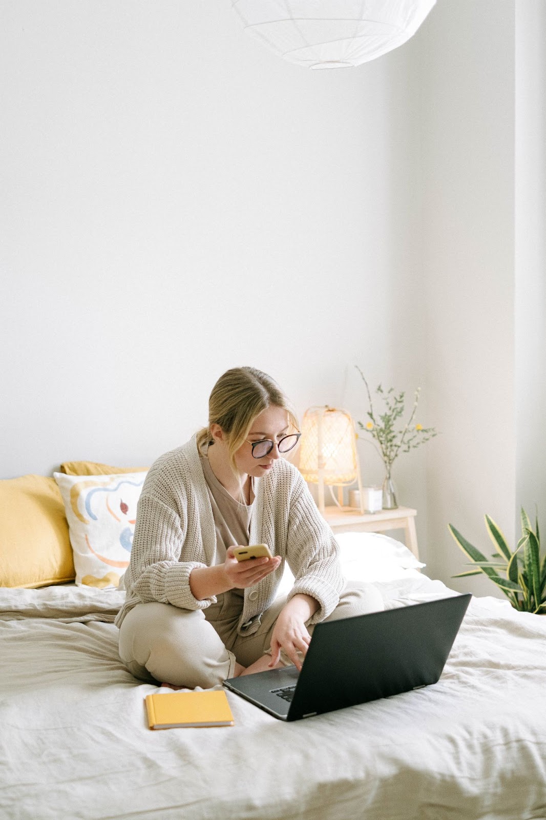 Woman in bed with Electronics before sleep