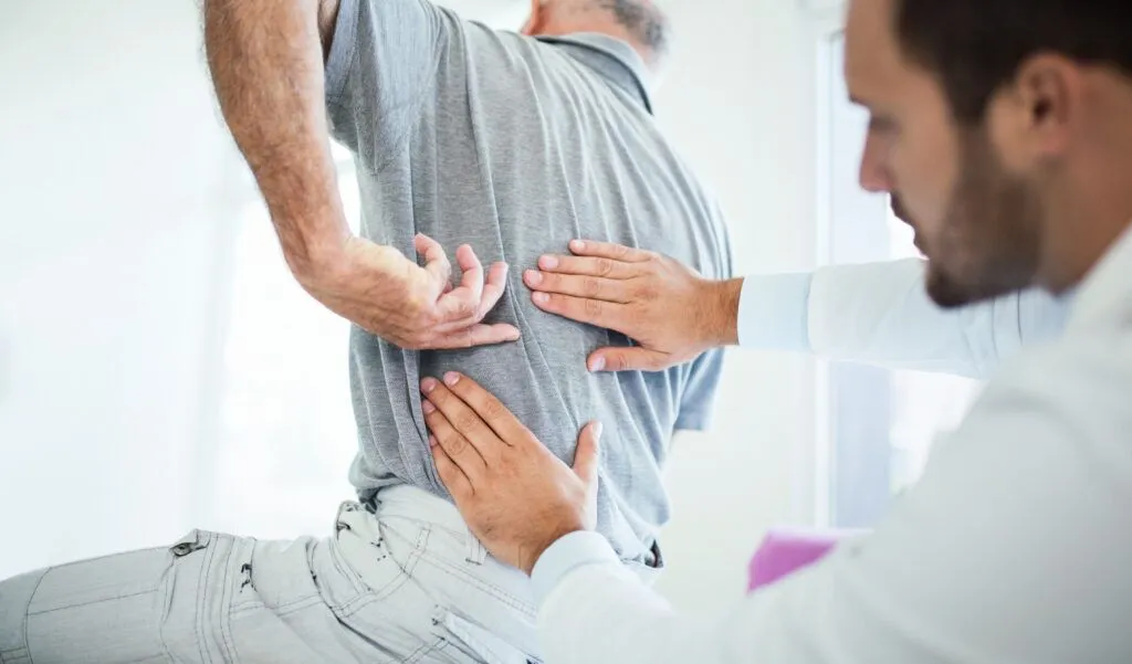 man receiving medical treatment after a car accident for pinched nerves and internal injuries